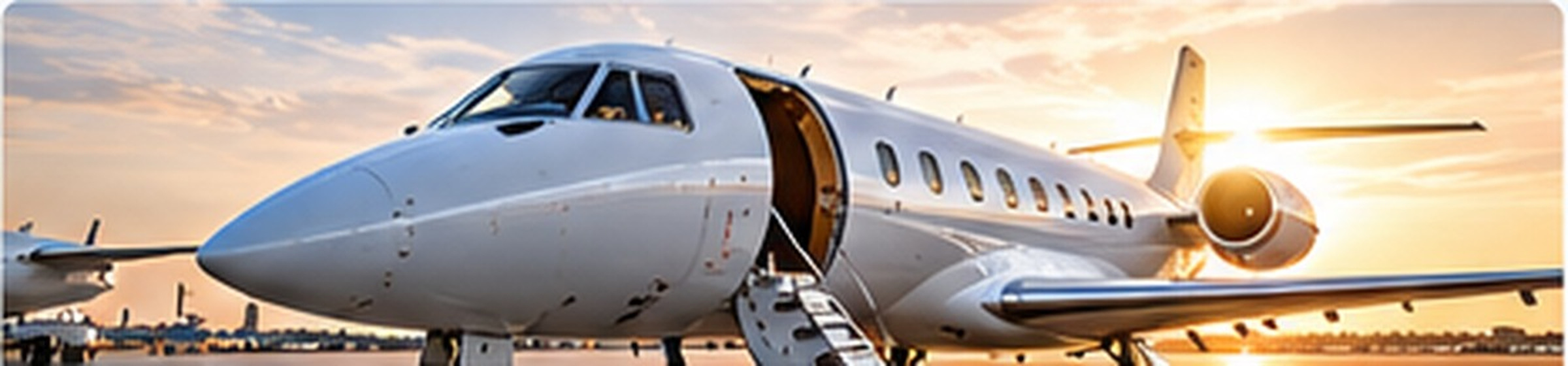 Unbranded business aircraft on an airport apron in warm evening light