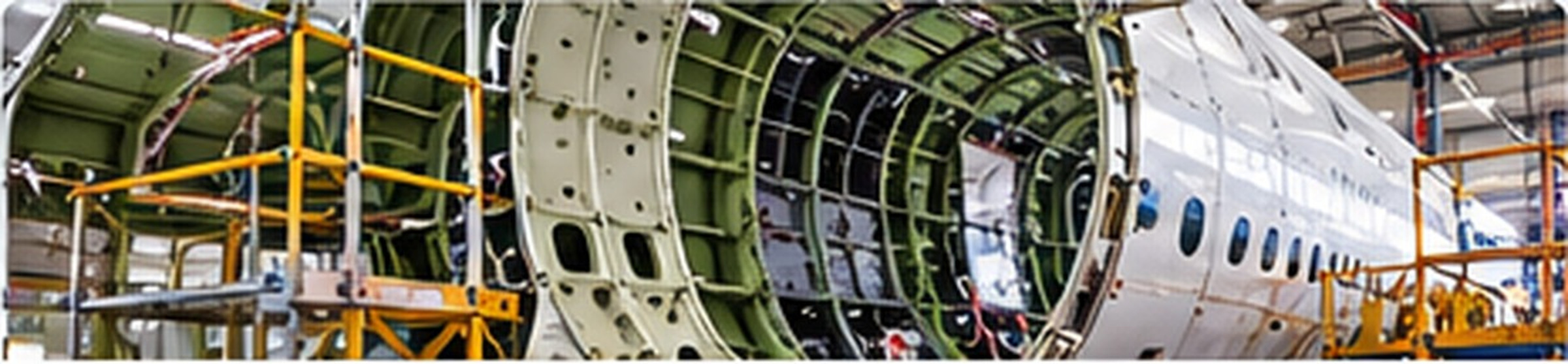 Aircraft airframe structure and exposed fuselage frames in a maintenance facility